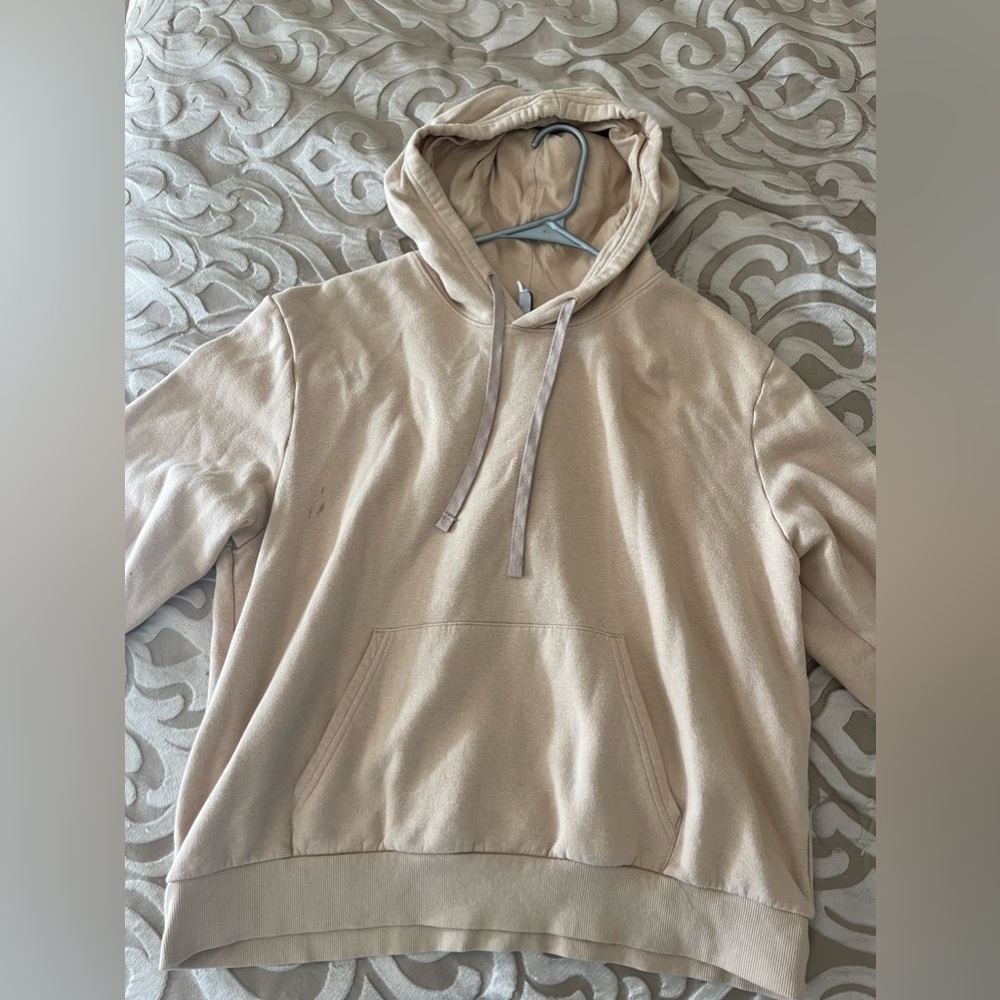 A yellowish beige oversized hoodie